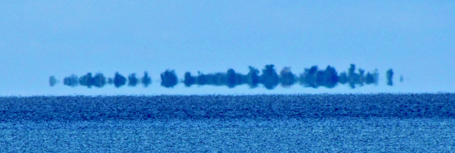 The Manitou Islands appearing to float above Lake Nipissing in a Fata Morgana mirage